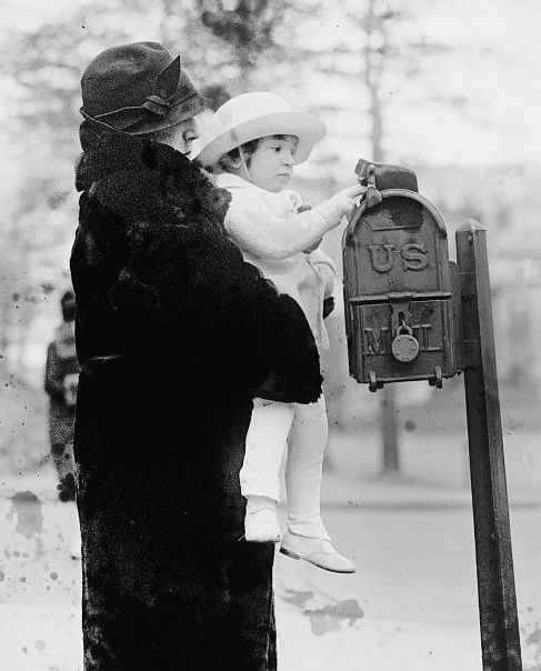 Photograph of child mailing letter to Santa Claus in 1925