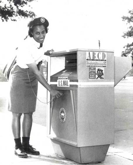 Photograph showing African-American Letter Carrier Evelyn Brown collecting mail from an experimental steel collection box in Washington, D.C., in 1967.