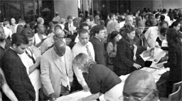 Postal employees accept passport applications from new U.S. citizens following the Citizenship and Immigration Service's naturalization ceremony in Orlando, Florida.