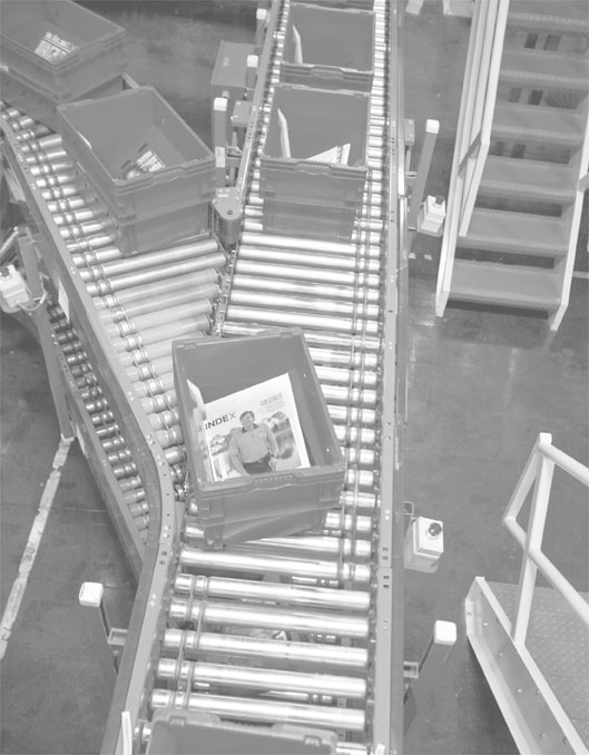 Mail processing tubs on a conveyor belt.