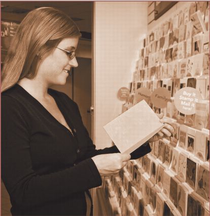 postal customer browsing cards at a postal retail outlet